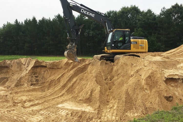 Excavator digging for a residential or commercial foundation